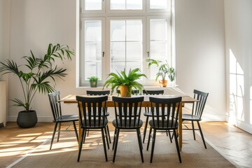 Modern dining room interior with a designed wooden table and black chairs, white walls and a big window, green plants in the corner of the space