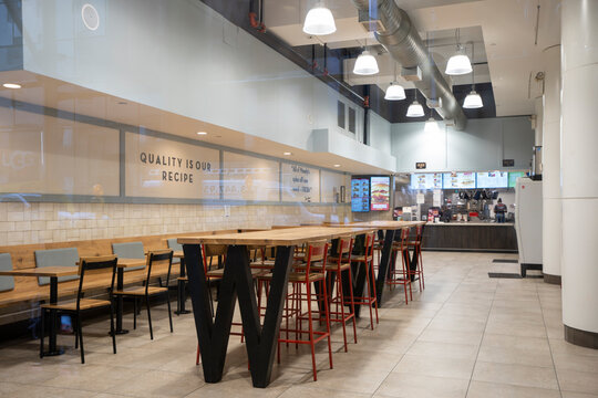 New York, NY, USA - July 9, 2022: The interior of a Wendy's restaurant viewed through the storefront window in New York City. Wendy's is an American fast food restaurant chain based in Columbus, Ohio.
