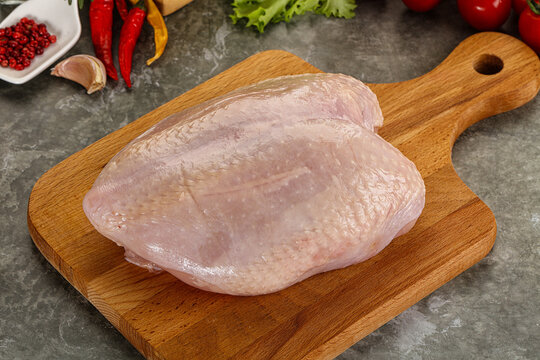 Raw chicken breast with skin