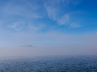 The Lake Czorsztynskie and fog rising from the water. Beautiful sky with clouds. Czorsztyn. Poland.