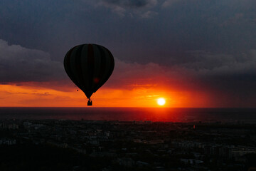 Serene Hot Air Balloon Flight Over City at Sunset