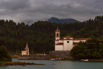 Church of Our Lady of Sorrows and the parish cemetery in the council of Llanes, next to the Barro estuary, Asturias.