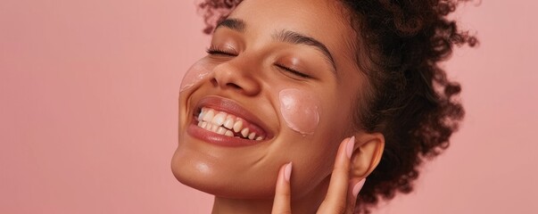 Joyful woman with skincare routine on a pink background
