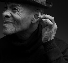 deaf man suffering from deafness and hearing loss on grey background with people stock photo	