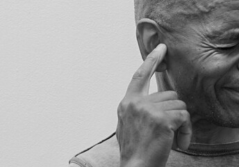 deaf man suffering from deafness and hearing loss on grey background with people stock photo	