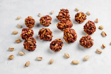 Superfood, raw healthy vegetarian snack, Medjool dates covered by chocolate, and various energy balls with nuts.