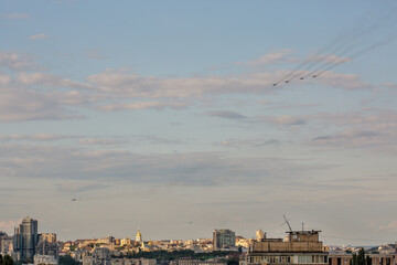 Kyiv aerial summer cityscape with flying military airplanes, Ukraine.