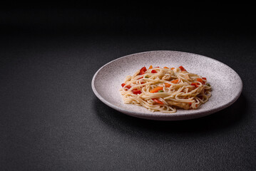 Delicious rice noodles or udon with chicken, carrots, pepper, salt, spices and herbs