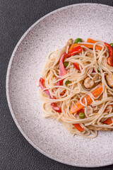Delicious rice noodles or udon with chicken, carrots, pepper, salt, spices and herbs