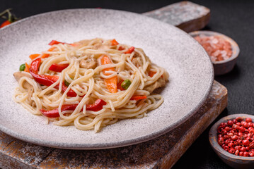 Delicious rice noodles or udon with chicken, carrots, pepper, salt, spices and herbs