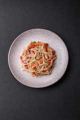 Delicious rice noodles or udon with chicken, carrots, pepper, salt, spices and herbs