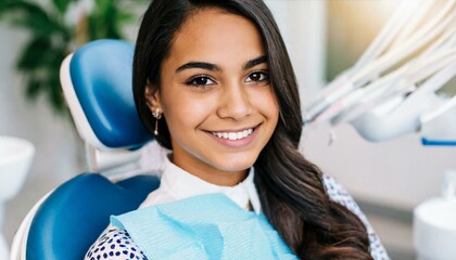 young woman with a radiant smile is sitting in a dental chair 