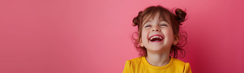 A child in yellow, with playful pigtails, against a vibrant pink backdrop, exuding warmth and youthful energy