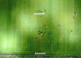 Aerial Top Down View of Soccer Football Field and Two Professional Teams Playing. 