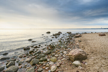 Stone beach in Gdynia-Orlowo during the sunset - 760066341