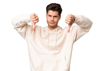 Young caucasian handsome man over isolated background showing thumb down with two hands