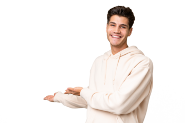 Young caucasian handsome man over isolated background extending hands to the side for inviting to come