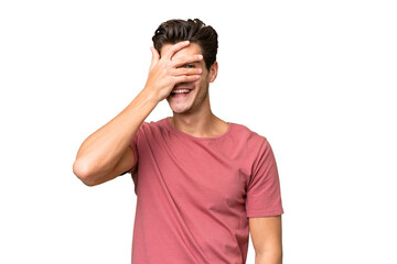 Young handsome caucasian man over isolated background covering eyes by hands and smiling - 760073324
