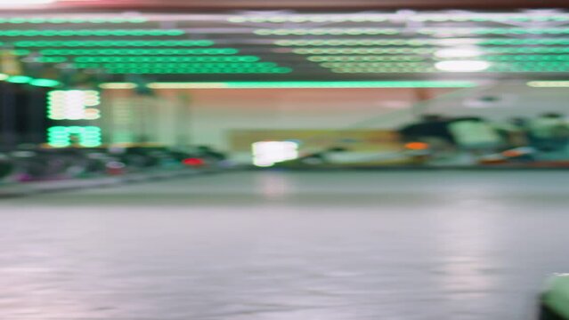 Joyful friends riding bumper car luna amusement park vertically. Girls resting