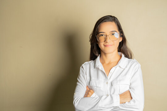 young latin business woman with glasses looking forward smiling conveying security and closeness