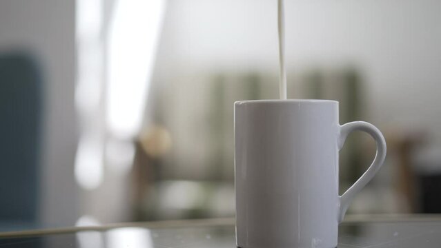 Adding milk to a cup of coffee