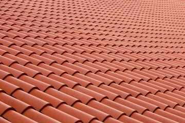 Roof made of tiles. Repeating tile elements. Painting tiles from a beautiful angle. Photo of the roof