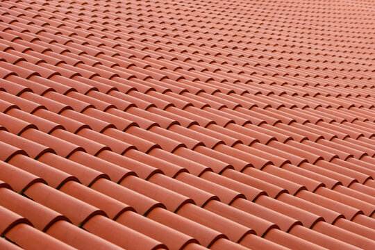 Roof made of tiles. Repeating tile elements. Painting tiles from a beautiful angle. Photo of the roof