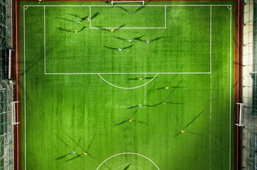 Aerial Top Down View of Soccer Football Field and Two Professional Teams Playing. 