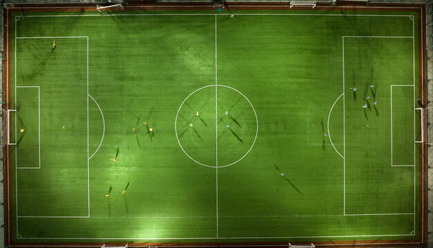 Aerial Top Down View of Soccer Football Field and Two Professional Teams Playing. 