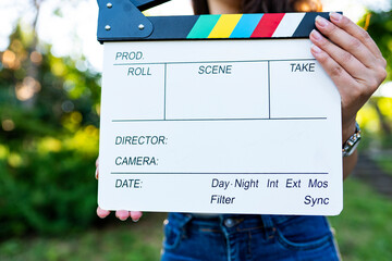 Photo of woman holding clapperboard 