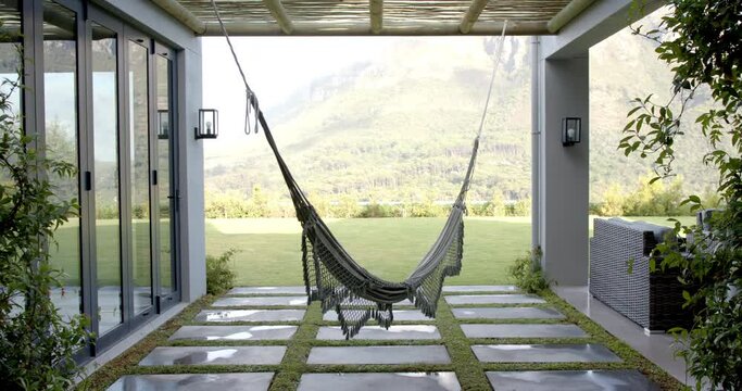 A hammock is strung in a serene outdoor patio with copy space