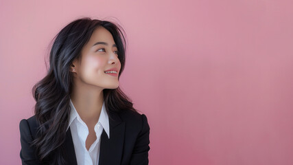 Malay businesswoman in black formal suit smiling isolated on pastel