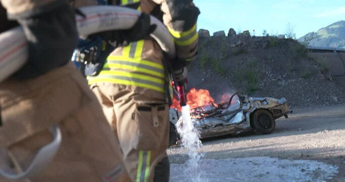 Firefighter training to extinguish a wrecked car
