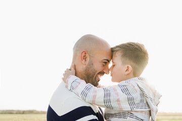Father and son having tender moment in park city. Happy family playing together. Dad love concept