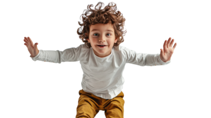 A young boy joyfully stands on a skateboard, ready to ride