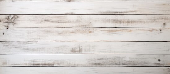 A closeup of a rectangular white wooden table with a blurred background. The table has a hardwood...