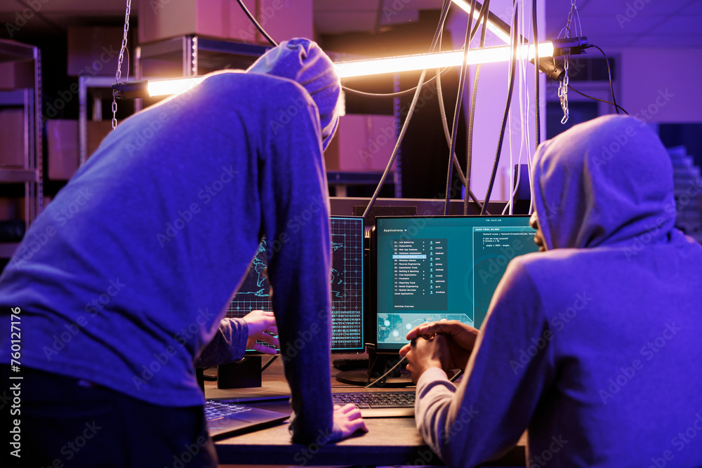 Poster two hackers running malicious software on computer screen to breach secure data. criminals group wea