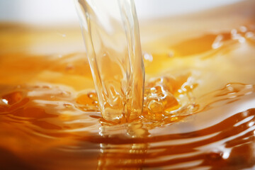 Close up of pouring golden liquid 