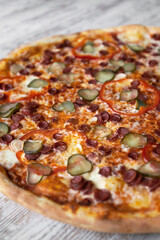 delicious tasty ham pizza with mushroom. light wooden table background