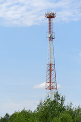 High metal transmission tower of telephone, radio and internet signal against the blue sky, telecommunication technology, 3g, 4g, 5g, wi-fi