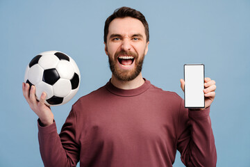 Overjoyed man, soccer fan holding mobile phone, soccer ball sports betting, win money, showing ...