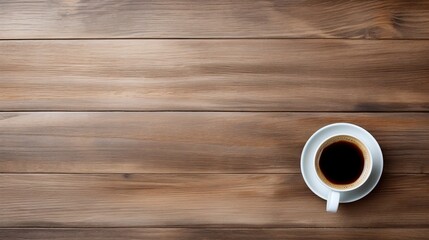 Overhead view of a steaming cup of coffee on a textured wooden backdrop, perfect for a cozy and warm start to the day