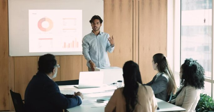 Leader make speech, reporting about finances, explain infographic shown on TV display, review statistical data engaged in professional seminar, briefing, negotiation with investors in conference room