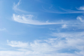 gentle cirrus clouds in a bright blue sky