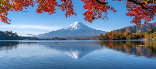Snow capped mtfuji, tallest volcano in tokyo, japan, amid autumn red trees, serene natural landscape - obrazy, fototapety, plakaty