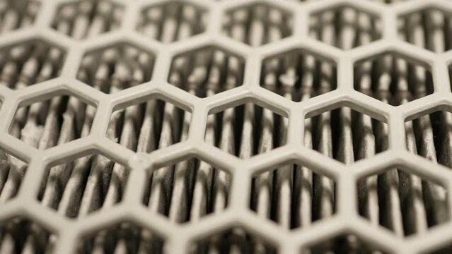Air filter macro shallow depth of field close up. Filter rotation in slow motion. Honeycomb shape pattern filter to relieve respiratory seasonal allergy, as Hay fever, Pollen count, Nasal congestion