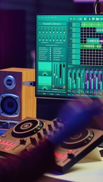 Vertical Video Audio engineer inserting an usb stick in the pc to record himself playing piano, mixing sounds and adjusting volume levels. Artist mastering audio recordings ready for release. Camera A