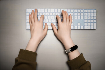 Overhead View of Hands Typing on Modern Keyboard
