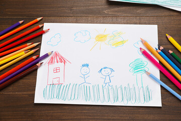 Cute child`s drawing and colorful pencils on wooden table, flat lay