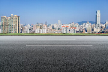 Empty City Road with Modern Urban Skyline